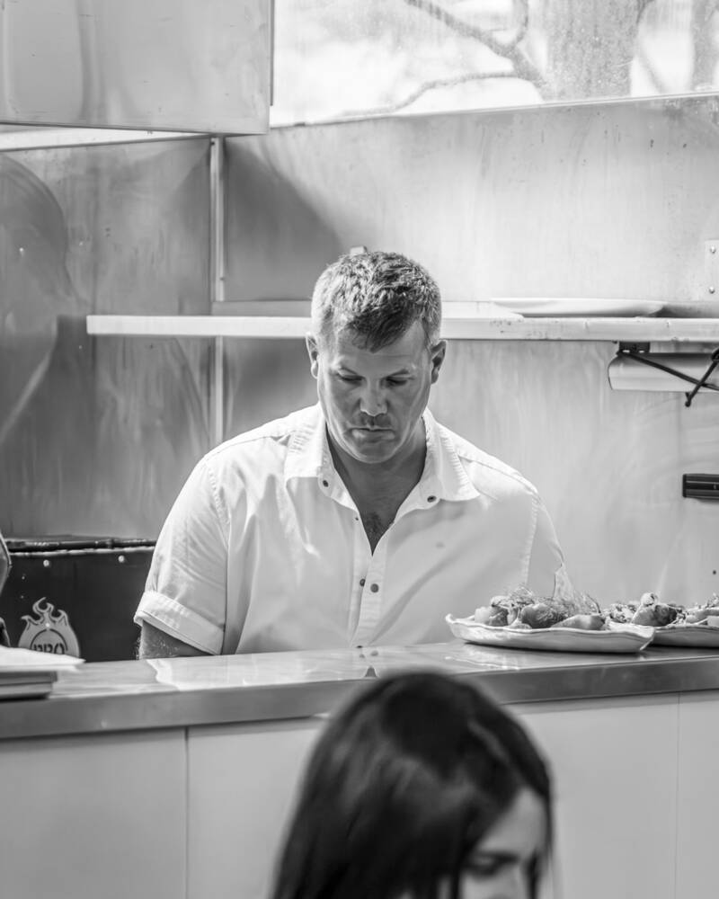 Chef James Orlowski working at the pass in the Estancia Adina kitchen