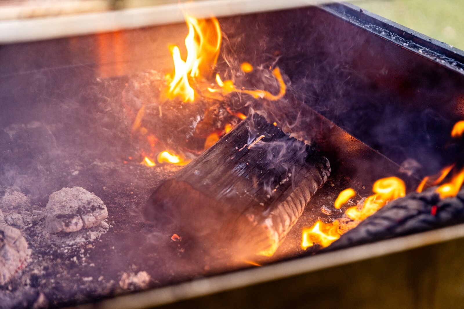 Wood burning down to coals in the open-fire grill at Estancia Adina