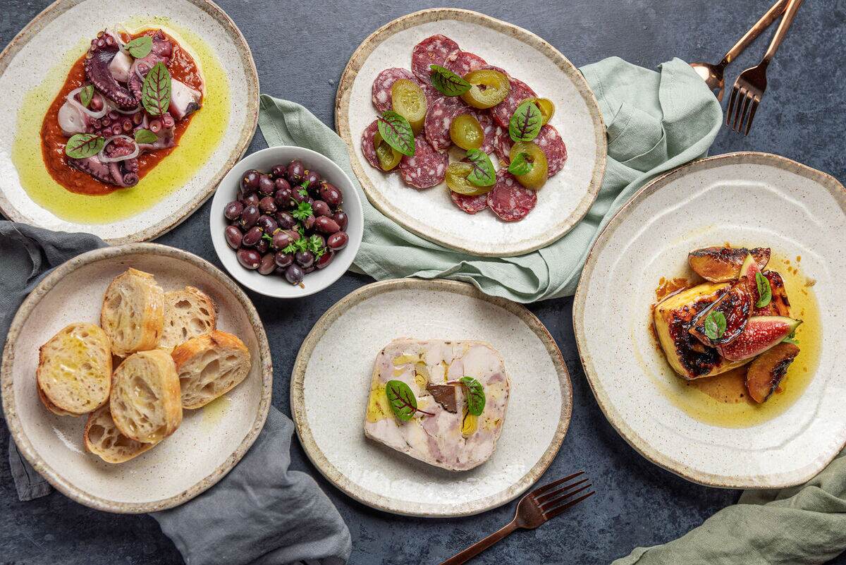 An overhead spread of shared plates at Estancia Adina
