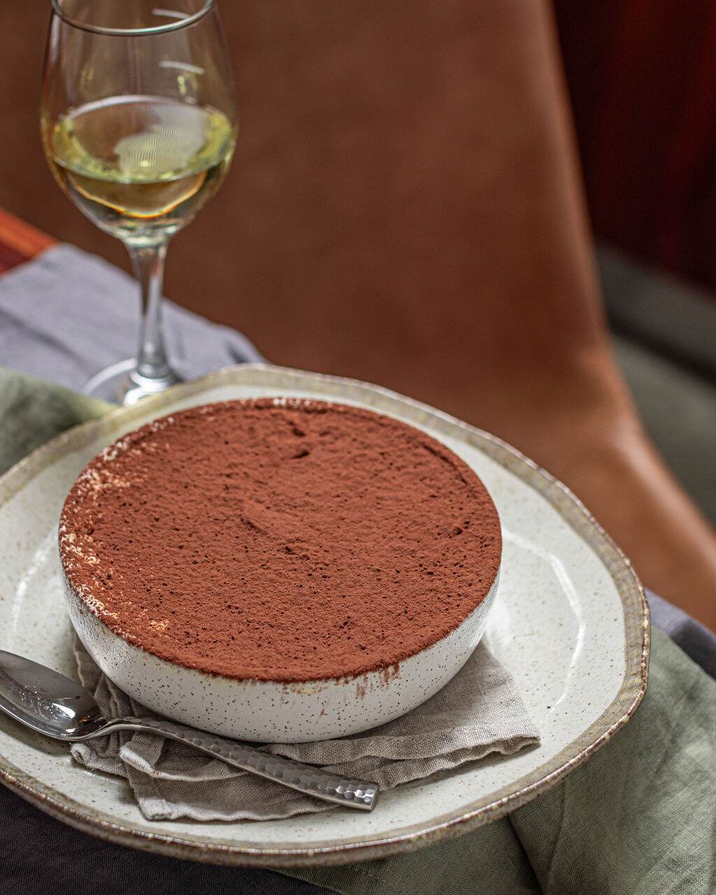 Cocoa-dusted tiramisu served with a glass of Adina white wine