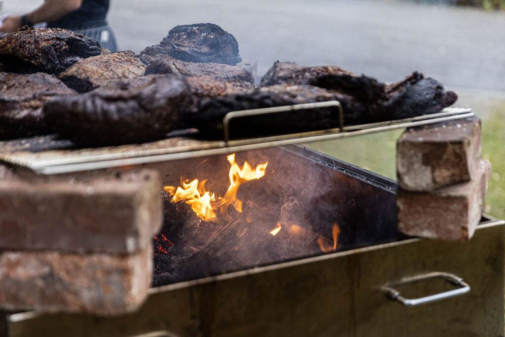 Cuts of meat cooking over the open-fire parrilla